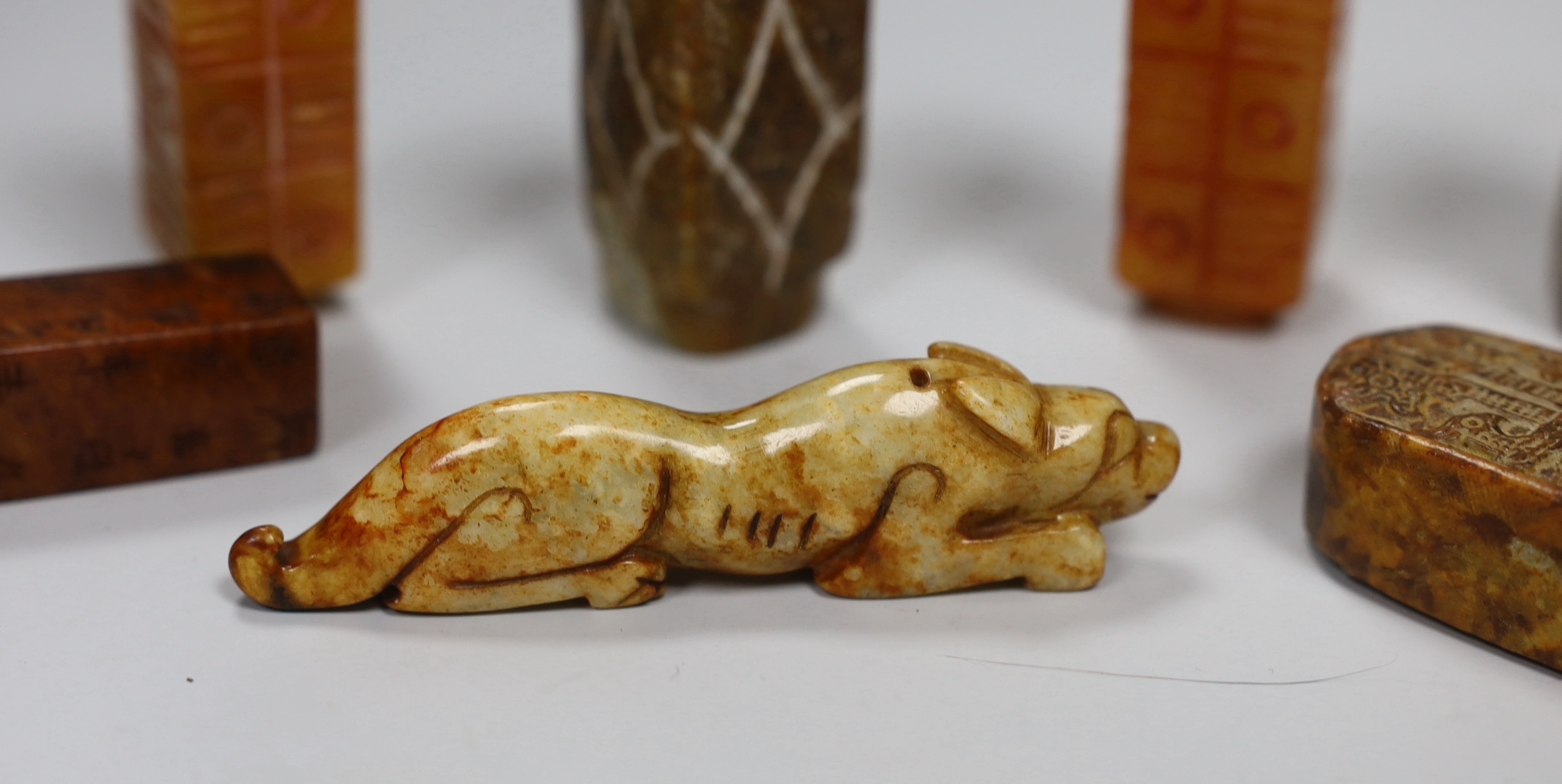 Eight Chinese archaistic jade or hardstone pendants/beads with carved decoration, the largest 9cm wide